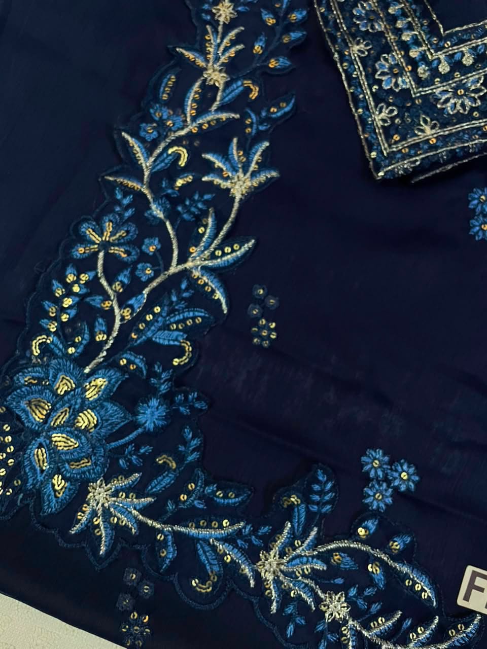 Embroidered border and floral motif detail